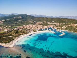 an aerial view of a beach with turquoise water at CASA DELEDDA in Budoni