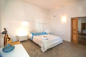 a bedroom with a bed and a guitar in it at CASA DELEDDA in Budoni
