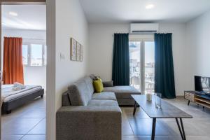 a living room with a couch and a table at Olive 2-Bedroom Apartment in Larnaca in Larnaka