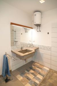 a bathroom with a sink and a large mirror at CASA DELEDDA in Budoni +21 photos