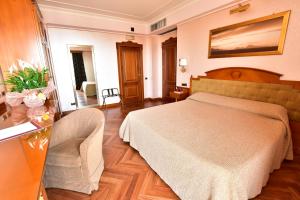 A bed or beds in a room at Palazzo Rosenthal Vesuview Hotel & Resort