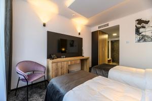 Postel nebo postele na pokoji v ubytování B THE HOTEL