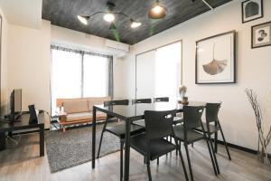 a dining room with a table and chairs at SERENAR Minami 13 Jo 8F in Sapporo