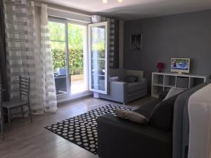 a bedroom with a couch and a living room with a window at Studio Disneyland Paris - Terrasse in Montévrain +13 photos