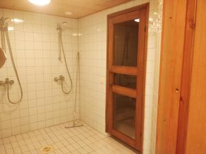 a bathroom with a shower and a glass door at Hotelli Patruuna in Imatra