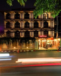 a building at night with a street in front at Sanae' Oldtown Hotel in Chiang Mai