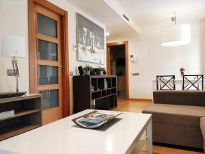a living room with a couch and a table at Mazi Apartments Downtown in Mataró