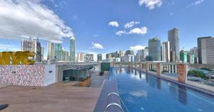 a pool on the roof of a building with a city skyline at OYO 563 Mytown New York in Manila