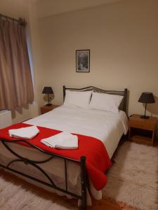 a bedroom with a large bed with two towels on it at Traditional Guesthouse Vrigiis in Agios Germanos