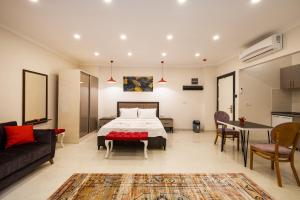 a bedroom with a bed and a living room at Sunrise City Residence in Fethiye