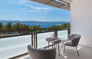 a view from the balcony of a house with a table and chairs at Bluesun Hotel Elaphusa in Bol