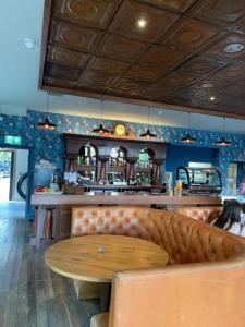 a restaurant with a wooden table and a bar at Loch Lomond Hotel in Balloch +74 photos