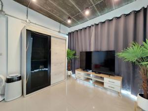a living room with a large flat screen tv at Boxsoon Nimman 3 # 4beds 4baths in Chiang Mai