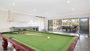 a pool table in a living room with a pool ball at Sutton Forest Retreat The Hideaway in Sutton Forest