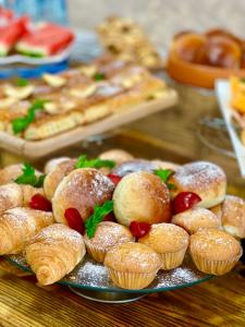 a plate of muffins and other pastries on a table at Kamar Hotel Ijevan in Ijevan