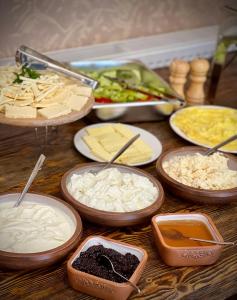 a table topped with bowls of different types of food at Kamar Hotel Ijevan in Ijevan