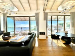 a living room with a couch and a table with a fireplace at Apt "Sunset Lounge" in Waase - Ummanz - Meerblick, Kamin, Sauna in Mursewiek