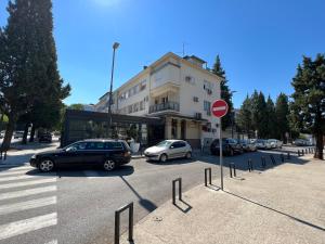 a parking lot with cars parked in front of a building at Green Hills II by Rent a car MI in Podgorica