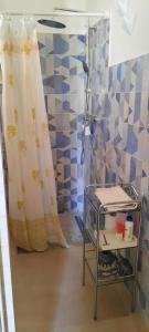 a shower in a bathroom with a shower curtain at Casa Poesia in Torre dell'Orso