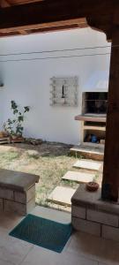 a patio with a grill and a table and a rug at Casa Poesia in Torre dell'Orso