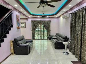 a living room with two couches and a ceiling at HOMESTAY D' SEPANGAR HILLS in Kota Kinabalu