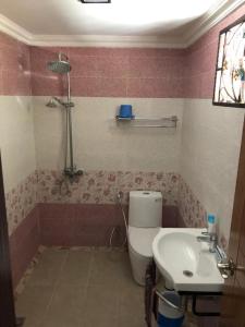a bathroom with a toilet and a sink at HOMESTAY D' SEPANGAR HILLS in Kota Kinabalu