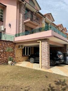 a car parked in a parking lot in front of a house at HOMESTAY D' SEPANGAR HILLS in Kota Kinabalu