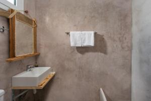 a bathroom with a sink and a mirror at Christos studios and family apartments in Rhodes Town