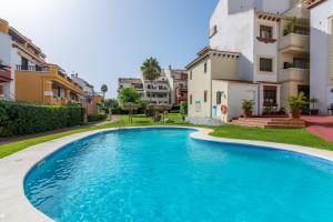 ein blauer Pool vor einigen Gebäuden in der Unterkunft Marina Esuri by HOMA in Ayamonte