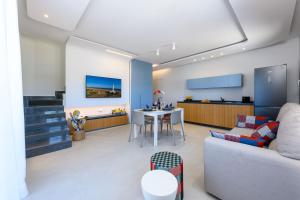 a living room with a couch and a table at Residence Luce del Mare in San Vito lo Capo