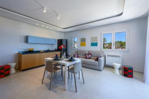 a living room with a table and a couch at Residence Luce del Mare in San Vito lo Capo