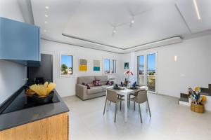 a kitchen and living room with a table and chairs at Residence Luce del Mare in San Vito lo Capo