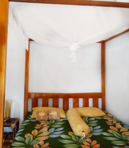 un dormitorio con una cama con un estampado de flores. en Sumatra Orangutan Discovery Villa en Bukit Lawang