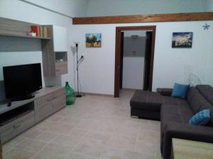a living room with a couch and a flat screen tv at DonVito Casa Vacanze in Alberobello