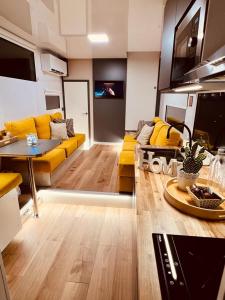 a living room with a yellow couch and a table at Different Charter in Vigo