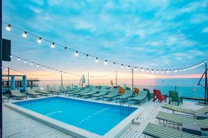 a swimming pool on a deck next to the ocean at Boulevardside in Batumi