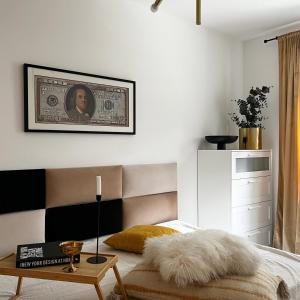 a bedroom with a bed and a table with a rug at Apartamenty Mieszczańska in Wrocław