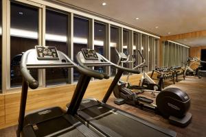 a gym with several cardio machines in a room at Nine Tree Premier Hotel Myeongdong 2 in Seoul