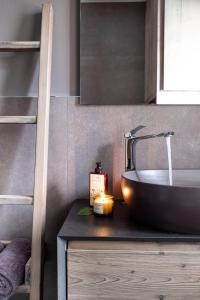 a bathroom with a sink and a counter with a sink at Suite Mia in Falcade