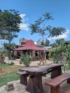 una mesa de picnic de madera frente a un edificio en VILLA OPA DOEL YOGYAKARTA, en Yogyakarta