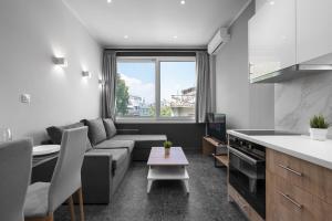 a kitchen and living room with a couch and a table at WallStreet, The Luxury Suites in Thessaloniki +253 photos