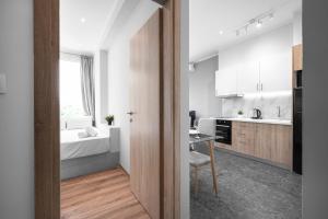 a kitchen with a desk and a bed in a room at WallStreet, The Luxury Suites in Thessaloniki