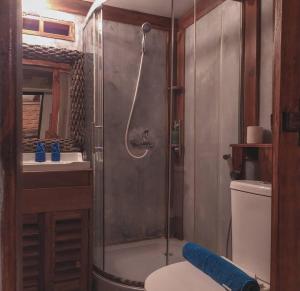 a bathroom with a shower with a toilet and a sink at VILLA OPA DOEL YOGYAKARTA in Yogyakarta