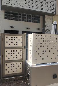 a bathroom with two drawers and a wall of windows at The City Gem Urban Apt. in Rhodes Town