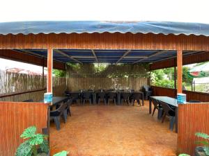 a restaurant with tables and chairs on a patio at Casa Raul Eforie Sud in Eforie Sud