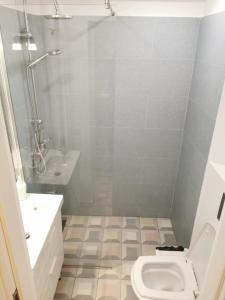 a bathroom with a toilet and a sink at Leedo Cozy Studio in Bucharest