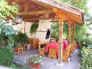 a patio with a table and an outdoor oven at Вила Любима in Yakovtsi