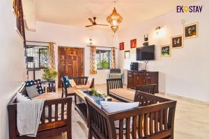 a living room with a table and chairs at EKOSTAY - Cozy Nest Villa in Karjat