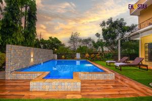 a swimming pool in a yard with a house at EKOSTAY - Cozy Nest Villa in Karjat