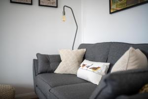 a living room with a gray couch with pillows on it at End House Inverness in Inverness